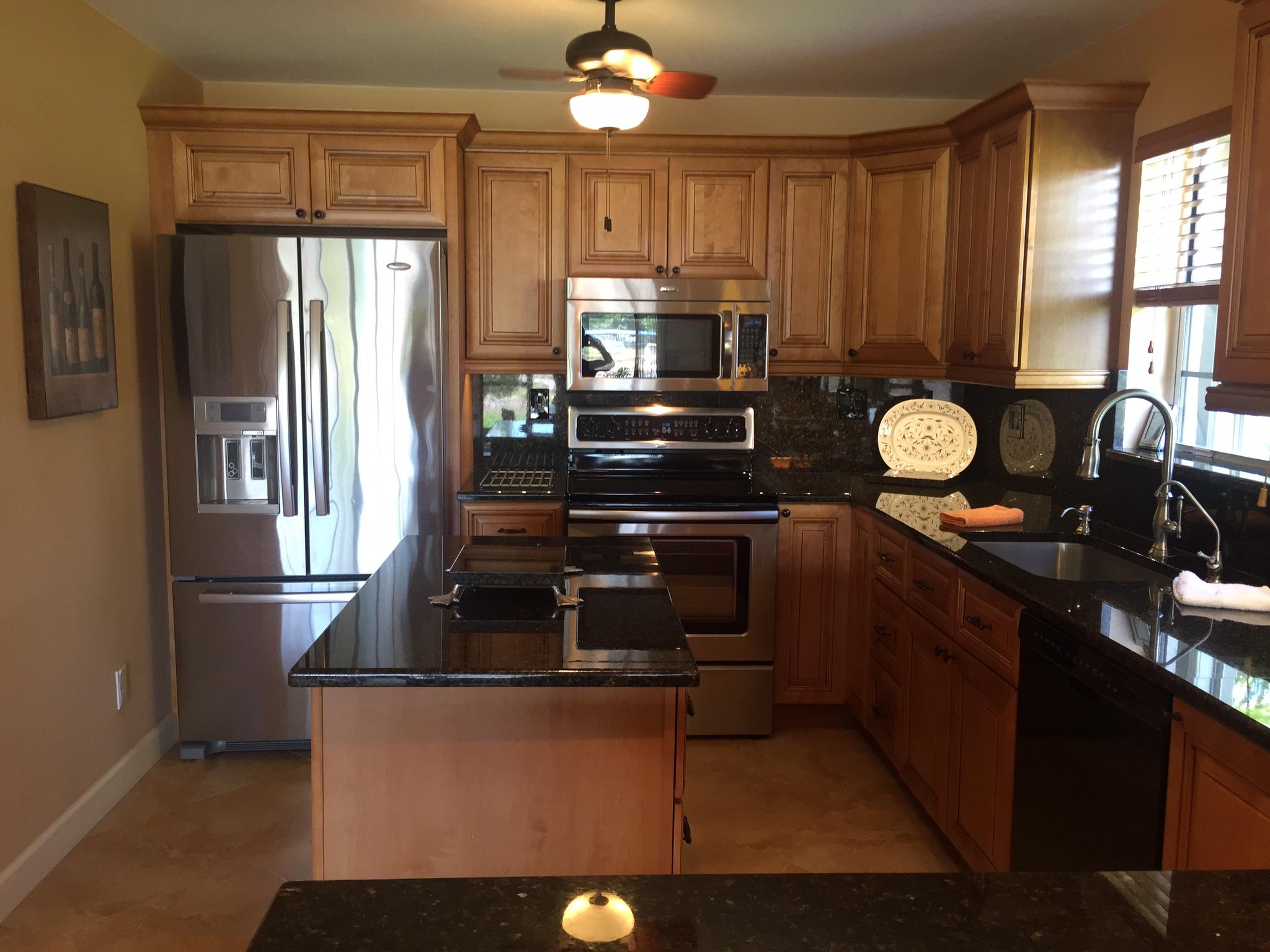 8904 Southwest 22nd Street, Unit H Boca Raton, FL 33433 - Photo 7 of 30 a kitchen with granite countertop a refrigerator stove and sink