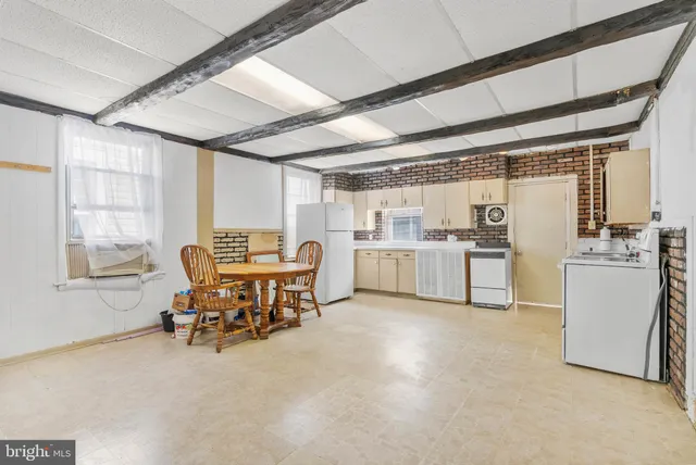 a view of a work space with furniture and windows