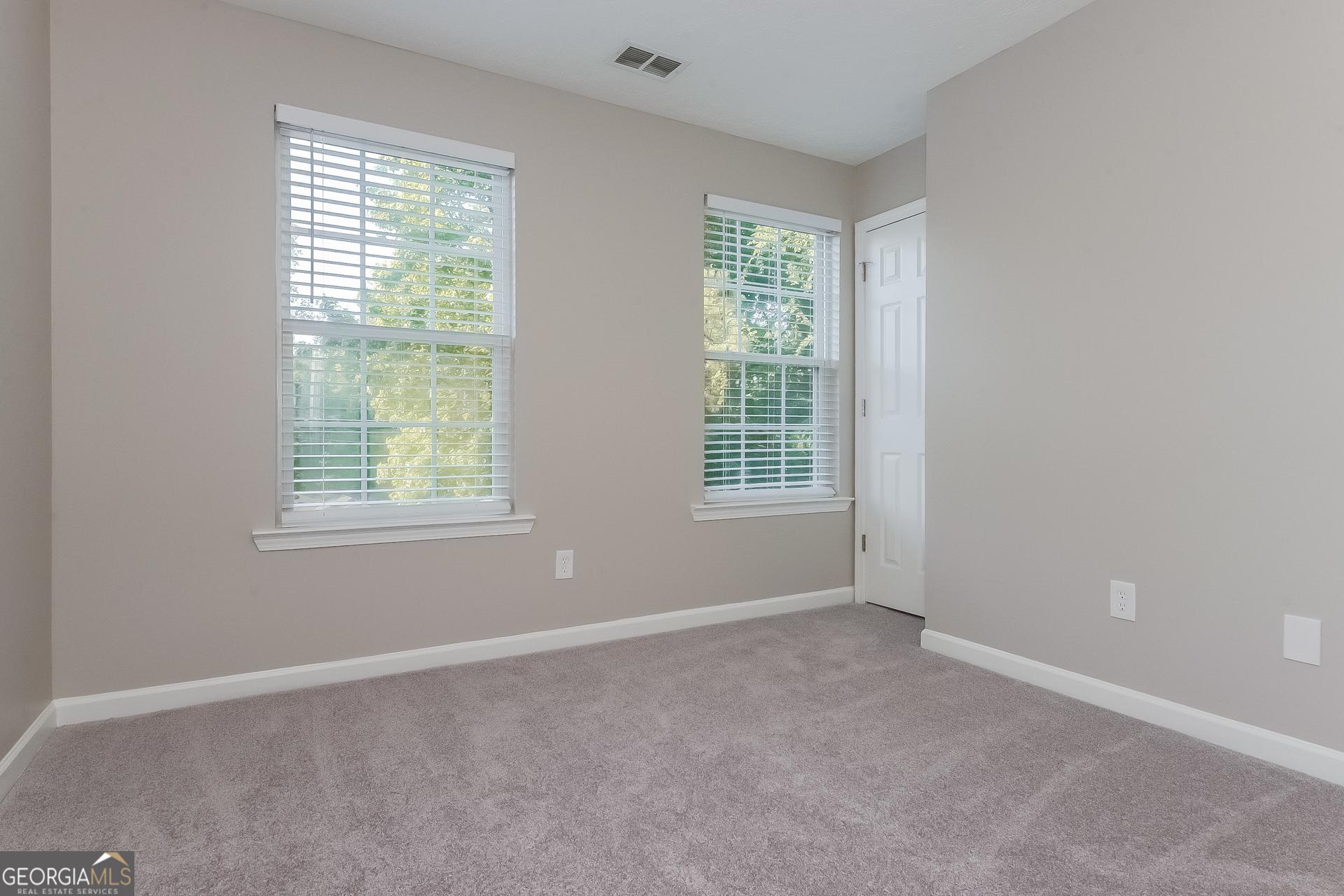 405 Hawthorne Circle Stockbridge, GA 30281 - Photo 11 of 17 an empty room with windows