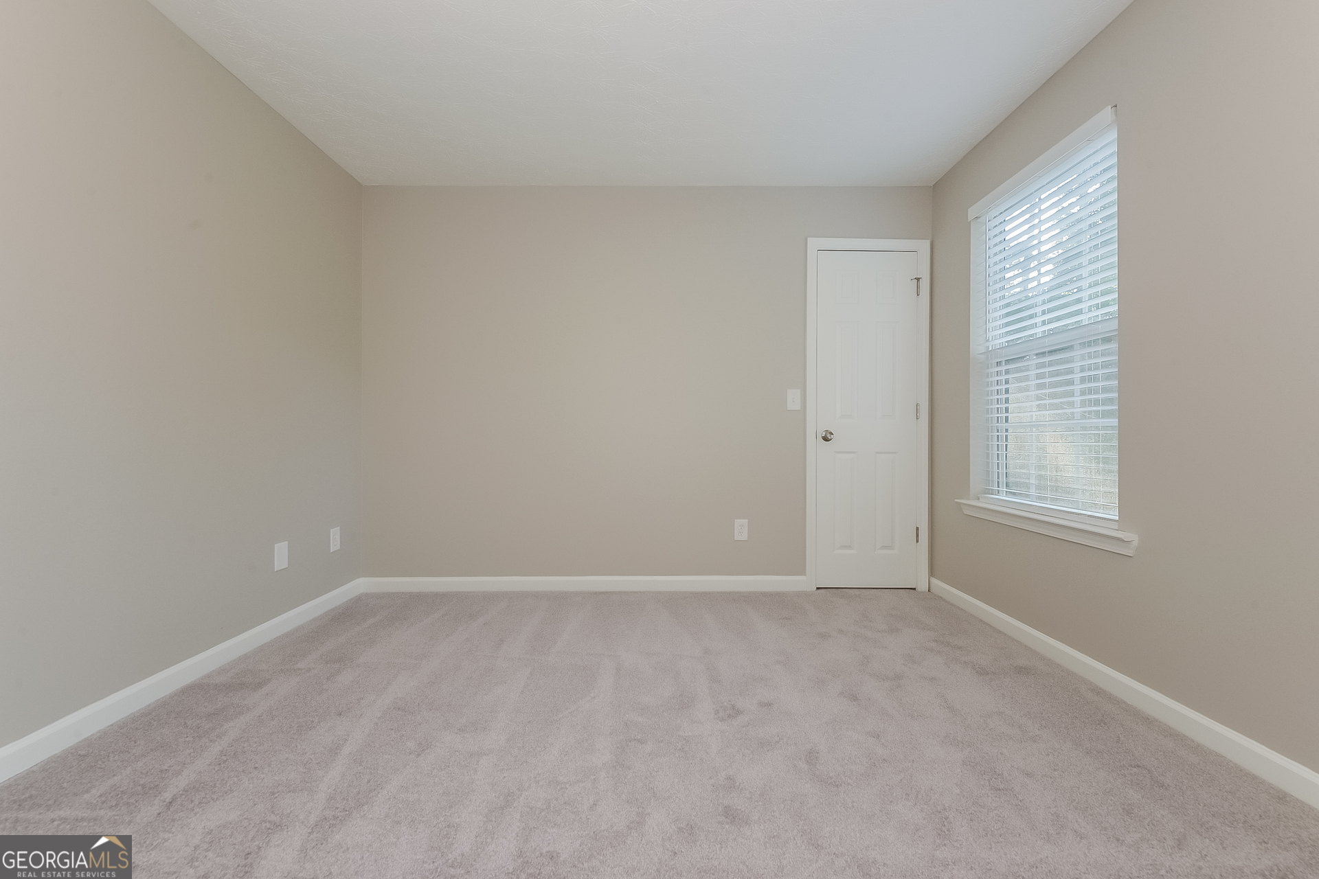 405 Hawthorne Circle Stockbridge, GA 30281 - Photo 12 of 17 a view of an empty room with a window