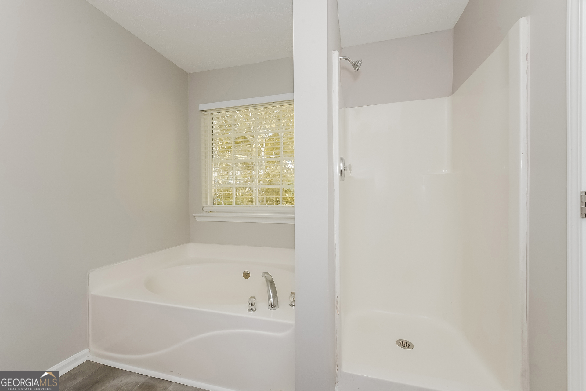 405 Hawthorne Circle Stockbridge, GA 30281 - Photo 13 of 17 a white bath tub sitting next to a shower