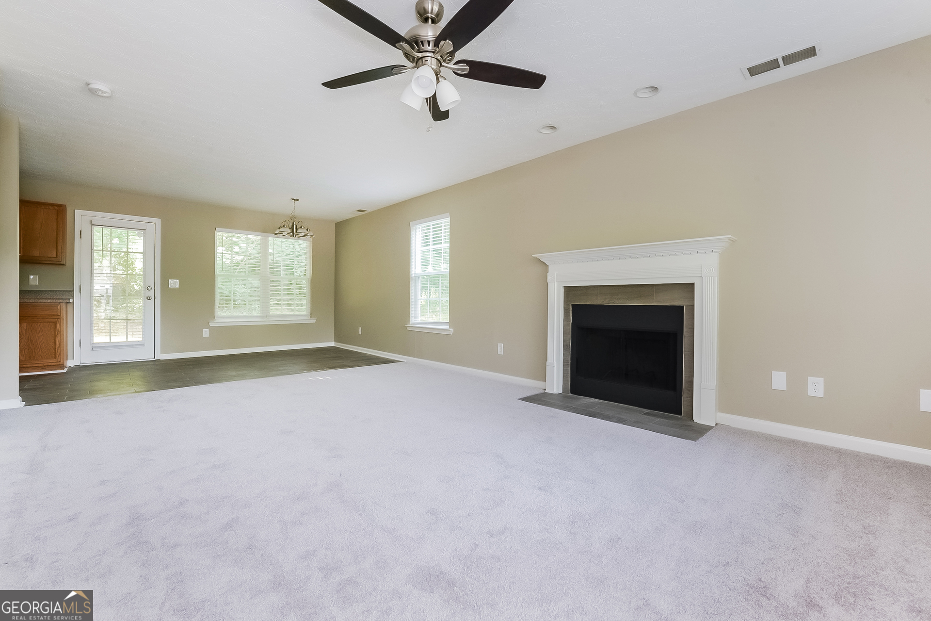 405 Hawthorne Circle Stockbridge, GA 30281 - Photo 2 of 17 an empty room with windows and fireplace