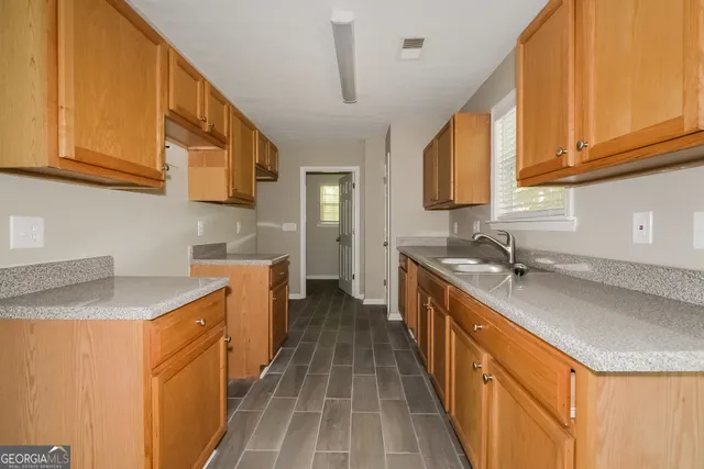a kitchen with a sink stove and cabinets
