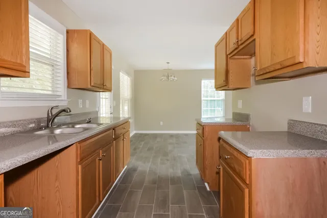 a kitchen with stainless steel appliances granite countertop a sink stove and cabinets