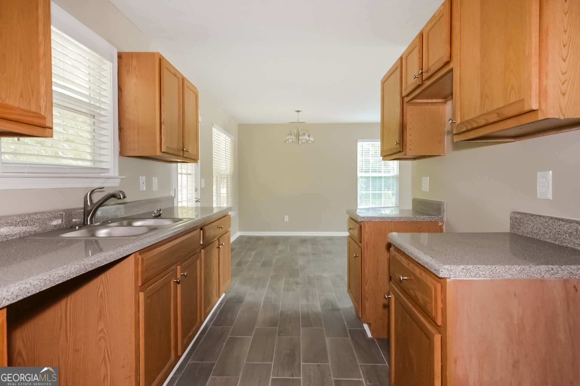 405 Hawthorne Circle Stockbridge, GA 30281 - Photo 6 of 17 a kitchen with stainless steel appliances granite countertop a sink stove and cabinets