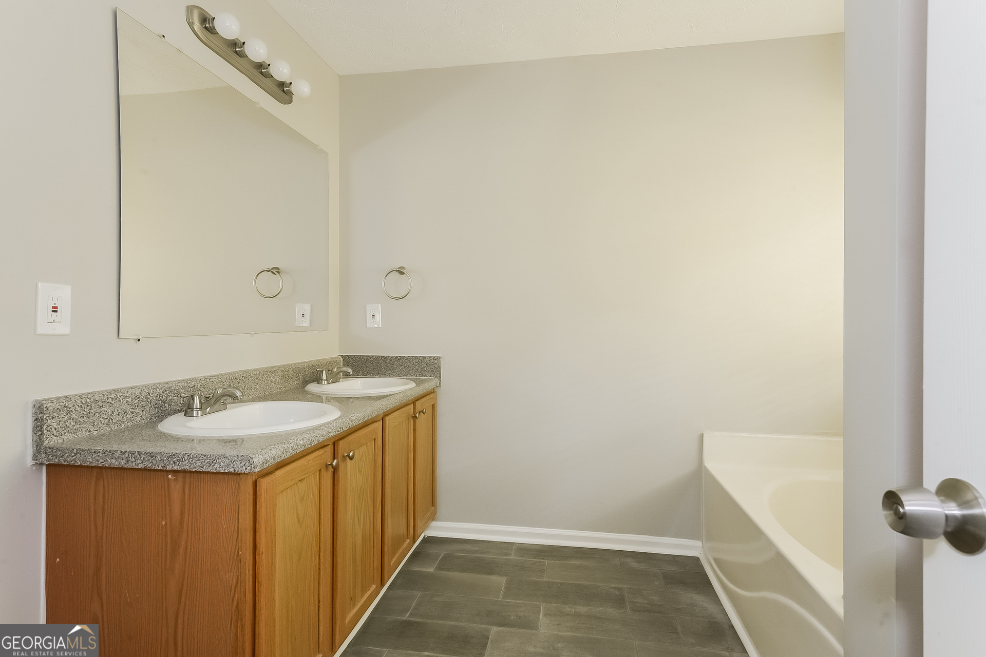 405 Hawthorne Circle Stockbridge, GA 30281 - Photo 9 of 17 a bathroom with a granite countertop sink and a mirror