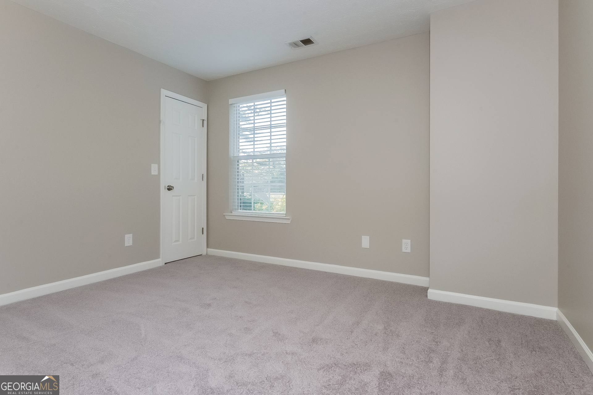 405 Hawthorne Circle Stockbridge, GA 30281 - Photo 10 of 17 a view of an empty room with a window