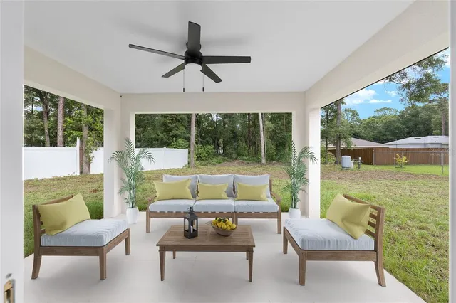 a living room with furniture and a floor to ceiling window