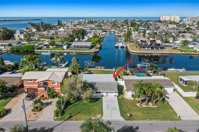 an aerial view of a house with a swimming pool outdoor seating