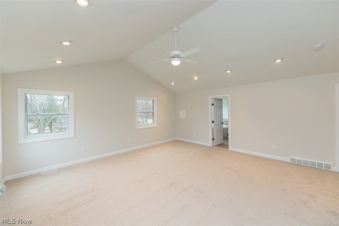 6947 Som Center Road Solon, OH 44139 - Photo 50 of 50 Carpeted spare room with lofted ceiling, a wealth of natural light, and ceiling fan