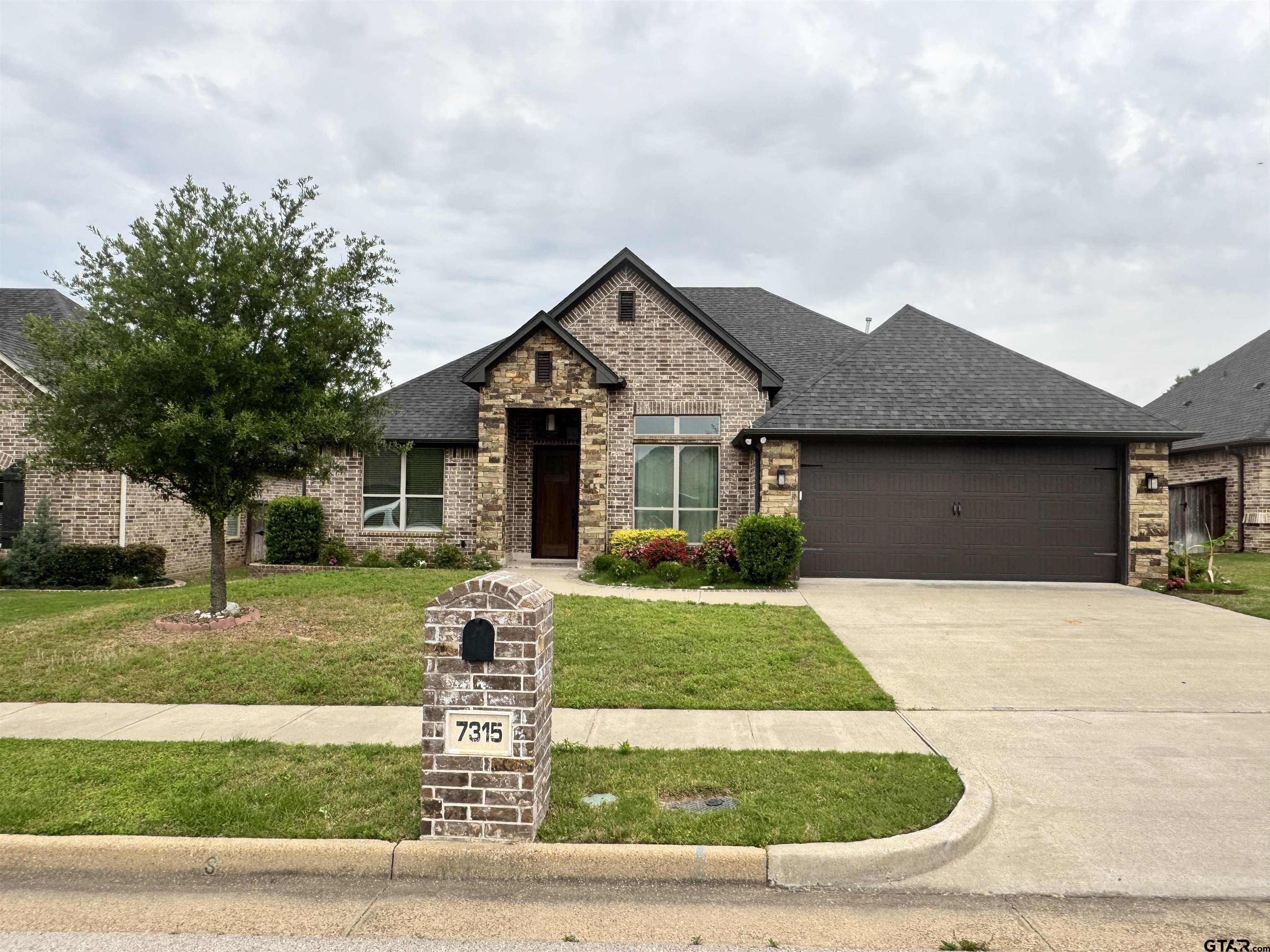 7315 Rolling Acres Place Tyler, TX 75707 - Photo 1 of 37 a front view of a house with a yard