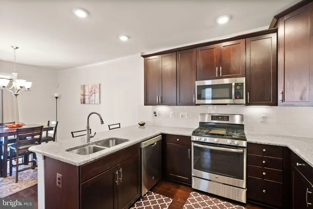 a kitchen that has a sink and a stove in it