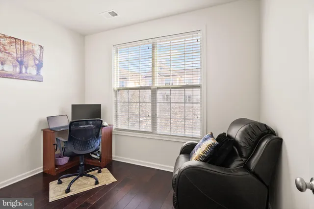 a livingroom with workspace and a window