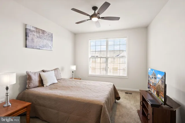 a bedroom with a bed and a television