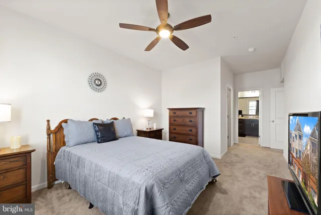 a bedroom with a large bed and a chandelier
