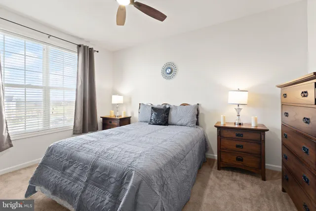 a bed room with a bed and a chair