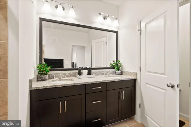 a bathroom with a double vanity sink and mirror