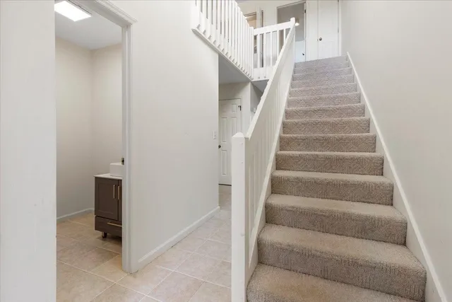 an empty room with fireplace and windows