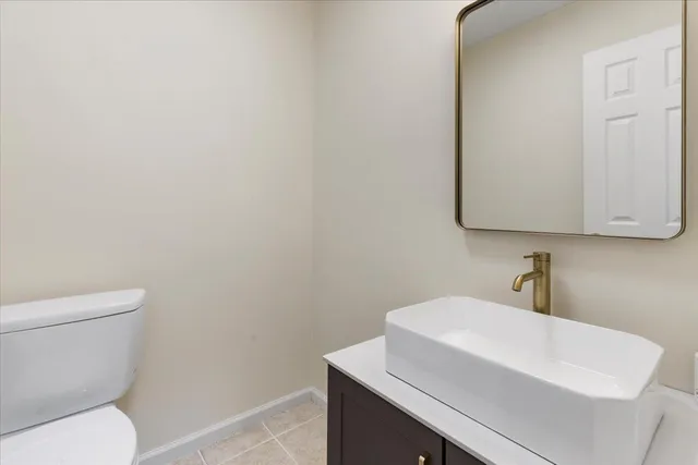 an empty room with windows and fireplace