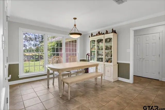a room with pool table and windows