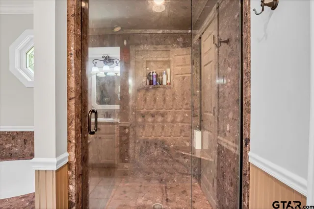 a bathroom with a glass shower door