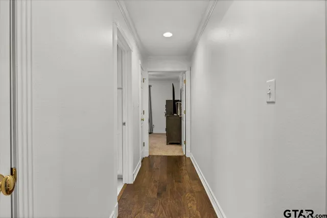 a view of a hallway with wooden floor