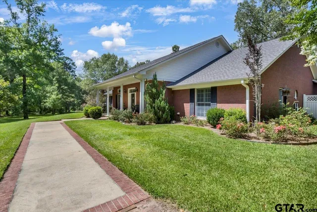a front view of house with yard and green space