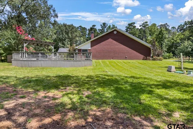 a view of an house with backyard space and garden