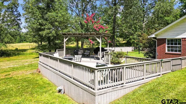 a view of a balcony with two large trees