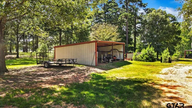a view of a house with a yard and sitting area