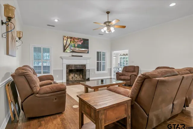 a living room with furniture a chandelier and a fireplace
