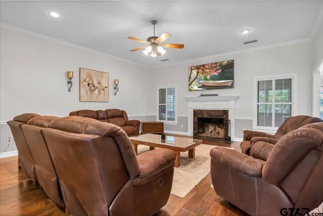 a living room with furniture a large window and a fireplace