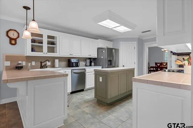 a kitchen that has a sink and a stove in it