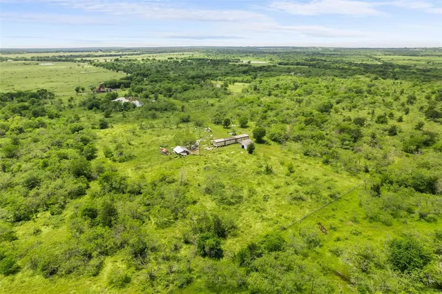 a view of a field with an ocean