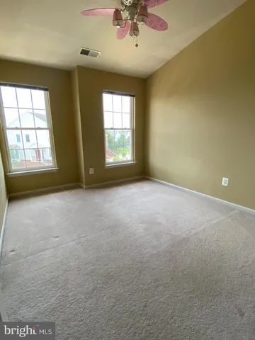 an empty room with a empty space and windows