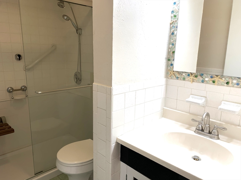 19 Atlantic Road, Unit 13 Gloucester, MA 01930 - Photo 17 of 17 a bathroom with a sink toilet vanity and shower
