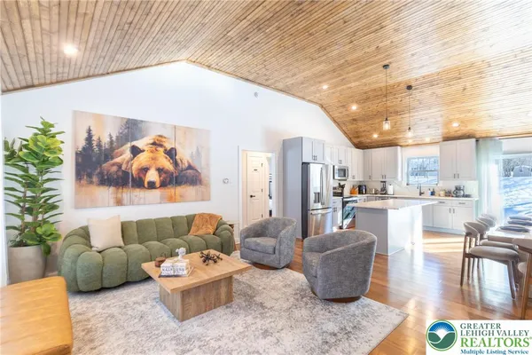 a living room with furniture and kitchen view