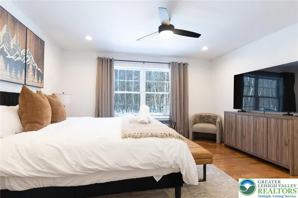 a bedroom with a bed and a large window