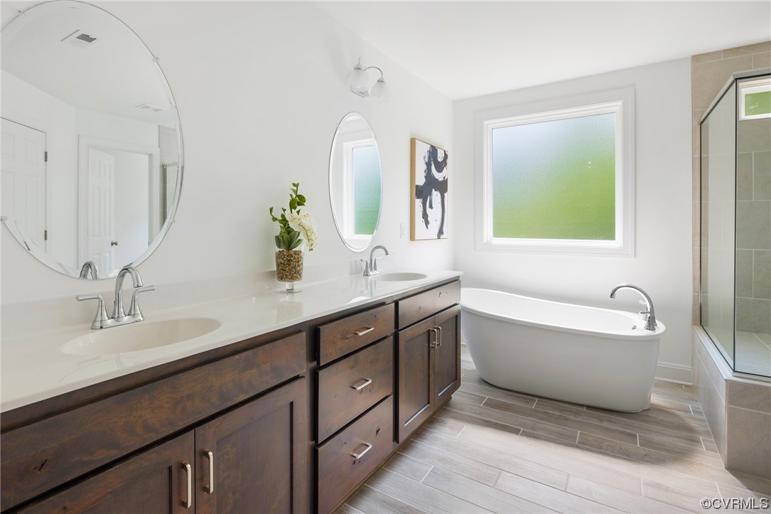 8357 Capernwray Drive Chesterfield, VA 23838 - Photo 33 of 50 a bathroom with a double vanity sink bathtub and mirror
