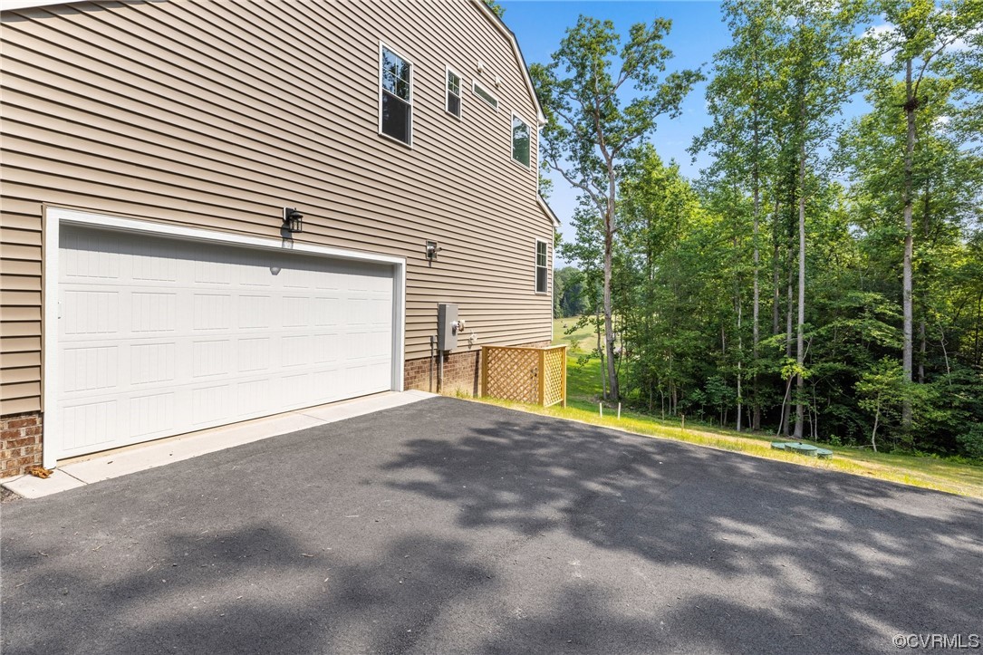 8357 Capernwray Drive Chesterfield, VA 23838 - Photo 49 of 50 a view of a house with a yard and garage