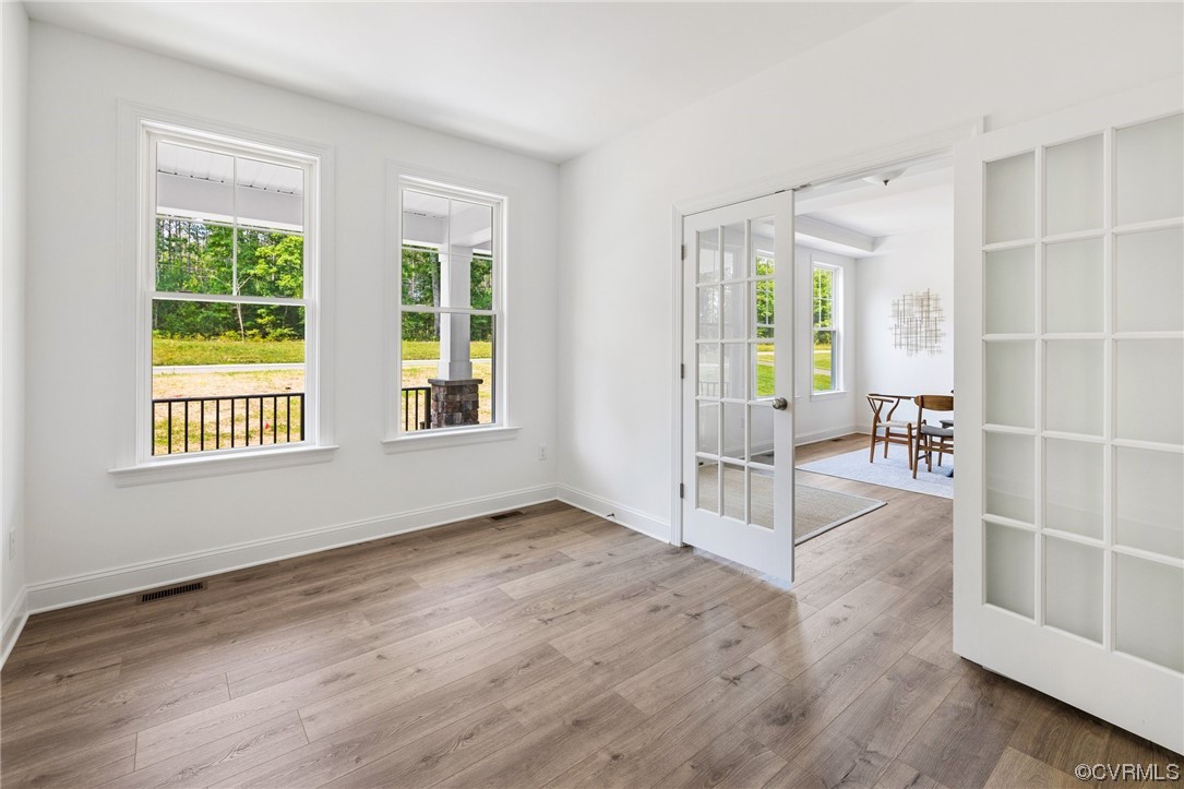 8357 Capernwray Drive Chesterfield, VA 23838 - Photo 9 of 50 a view of an empty room with a window and wooden floor