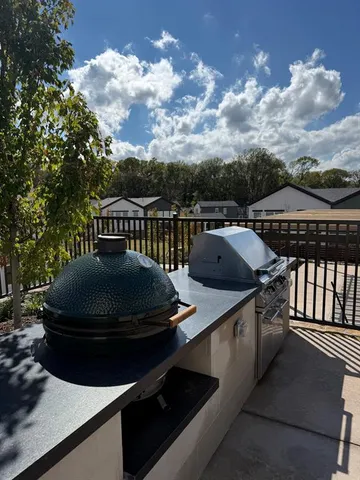 a roof deck with table and chairs