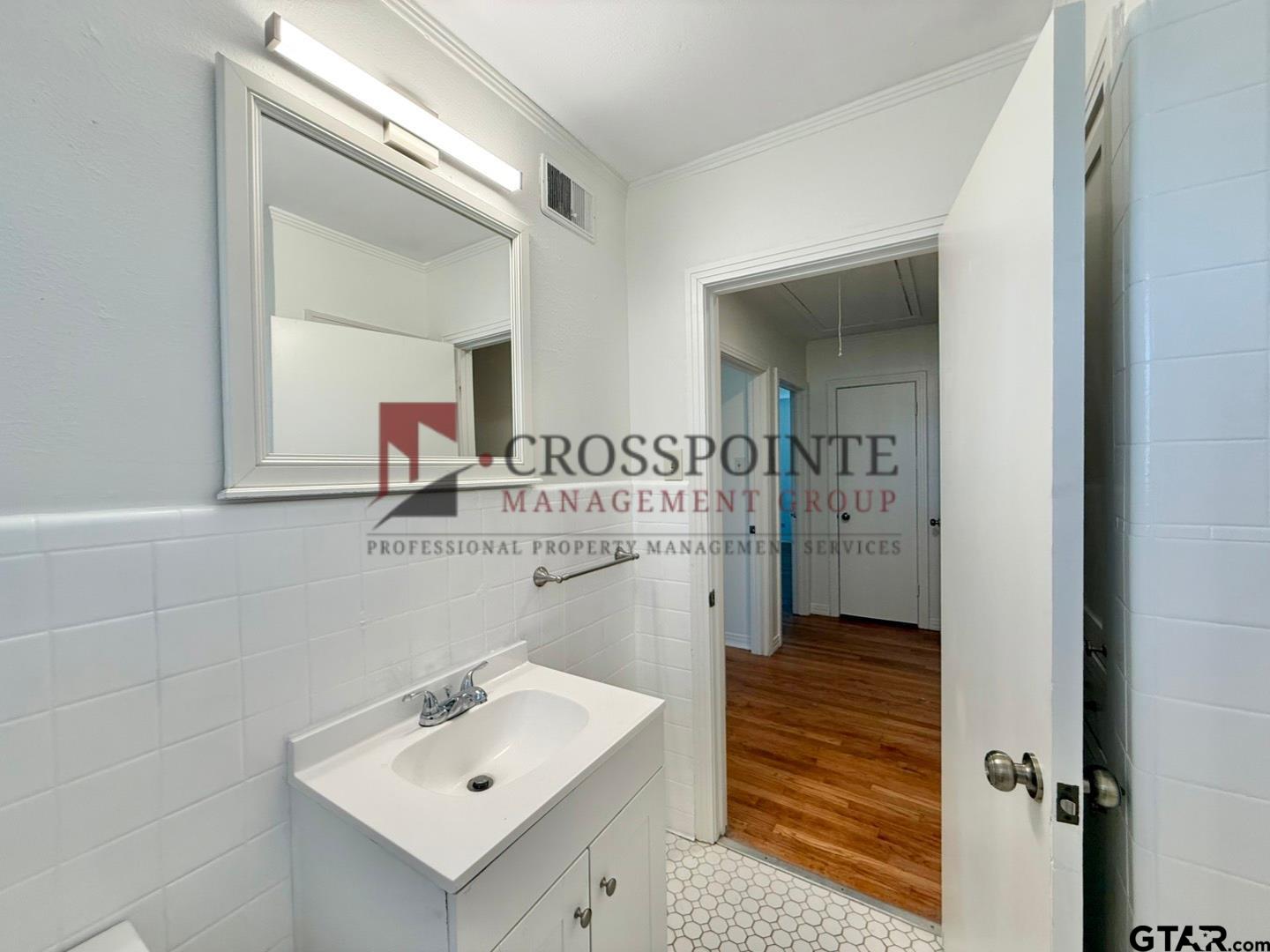 10120 FM 346 Flint, TX 75762 - Photo 22 of 35 a bathroom with a sink a mirror and a shower