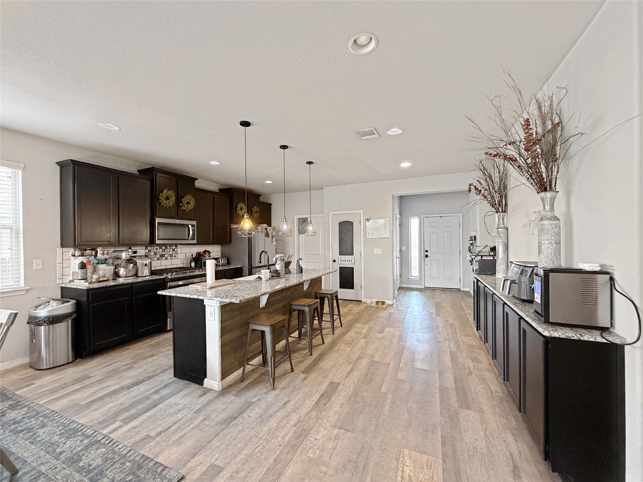 429 Rusk Bluff Avenue Leander, TX 78641 - Photo 3 of 24 A well-lit kitchen with a spacious island for gathering and meal preparation.