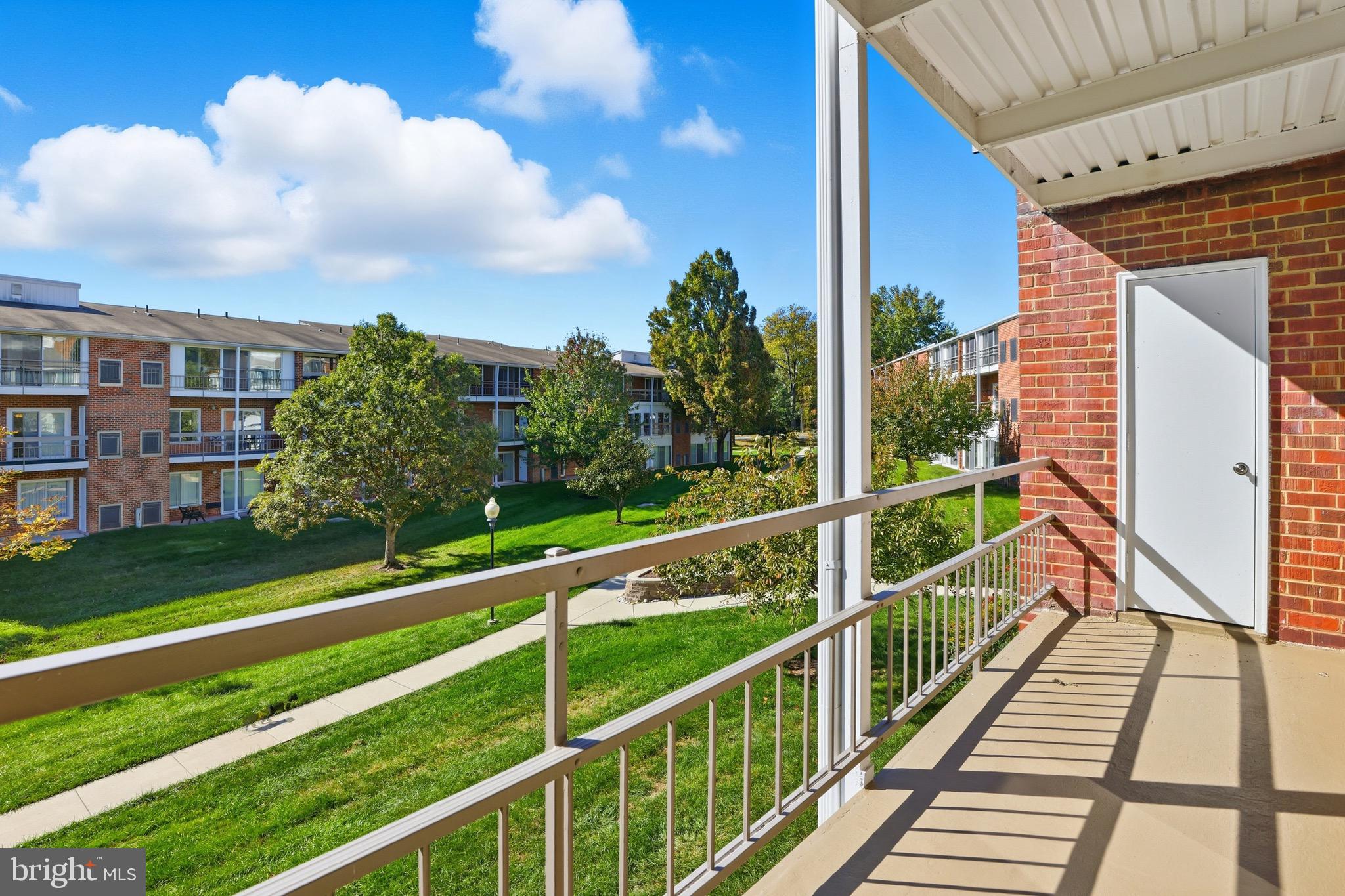 3500 Forest Edge Drive, Unit 152F Silver Spring, MD 20906 - Photo 13 of 31 a view of balcony with wooden floor and fence