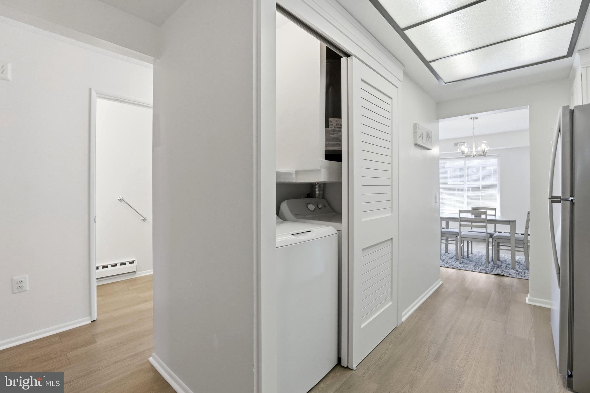 3500 Forest Edge Drive, Unit 152F Silver Spring, MD 20906 - Photo 19 of 31 a view of a hallway with wooden floor and a living room