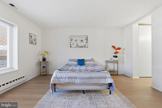 a spacious bedroom with a bed and a cabinets