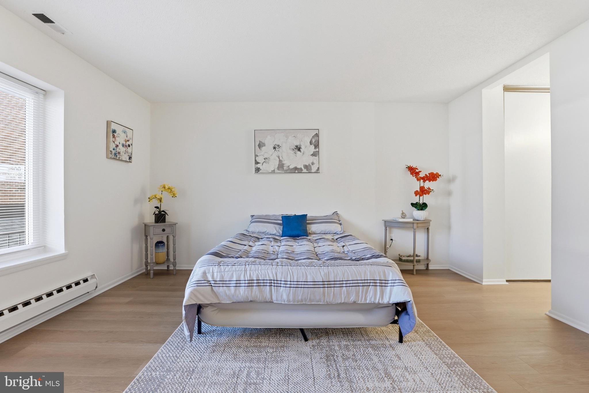 3500 Forest Edge Drive, Unit 152F Silver Spring, MD 20906 - Photo 23 of 31 a bedroom with a bed and a table