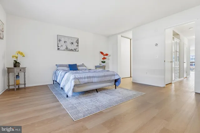 a bedroom with a bed and a painting on the wall