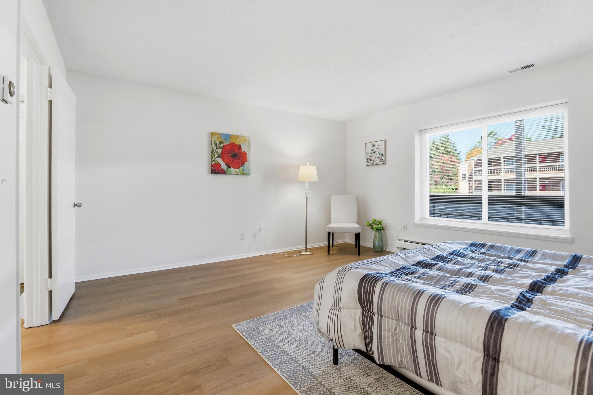3500 Forest Edge Drive, Unit 152F Silver Spring, MD 20906 - Photo 26 of 31 a bedroom with a bed and a window